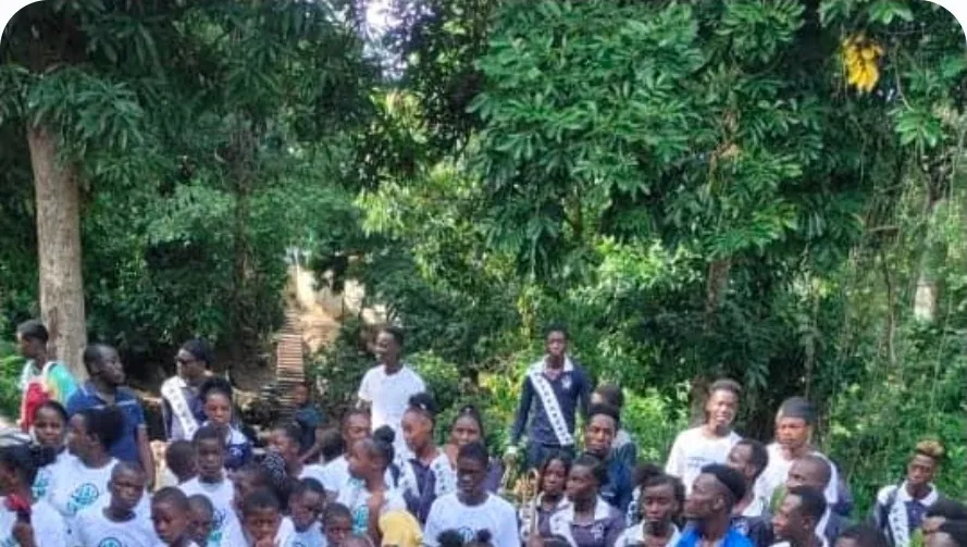 Children and volunteers in LYNN t-shirts gathered outdoors at a LYNN event in Haiti